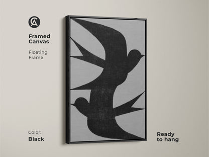 Framed canvas of minimalist wall art featuring an abstract black swallow flock. The floating frame color is black. This modern grey nature decor is ready to hang. This is perfect as bedroom wall art or a housewarming gift canvas for minimalist homes.