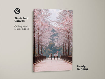 This stretched canvas art features a couple walking under cherry blossoms. It is a spring landscape photography print. The gallery wrap and mirror edges add a modern touch. Ready to hang this romantic couple wall art brings seasonal beauty into your home.