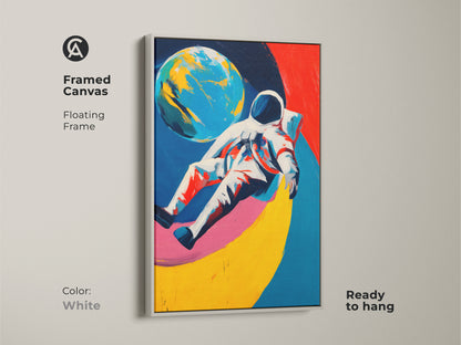 White framed canvas featuring an abstract astronaut and planet. Blue red and yellow colors create a modern look. This space themed canvas is ready to enhance your decor.