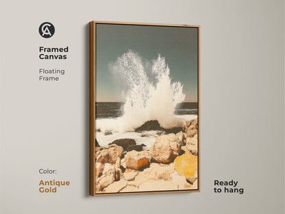 Framed canvas with white frame showing teal ocean wave art. Coastal seascape wall art print captures a crashing wave on a rocky shore. Ready to hang beach house canvas art adds coastal living charm providing the ocean's energy to any room.