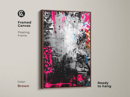 Framed canvas with a floating frame showcasing graffiti artwork in a brown frame. The monochrome art is accented by bold pink. Ready to hang adding a touch of urban sophistication to any room.
