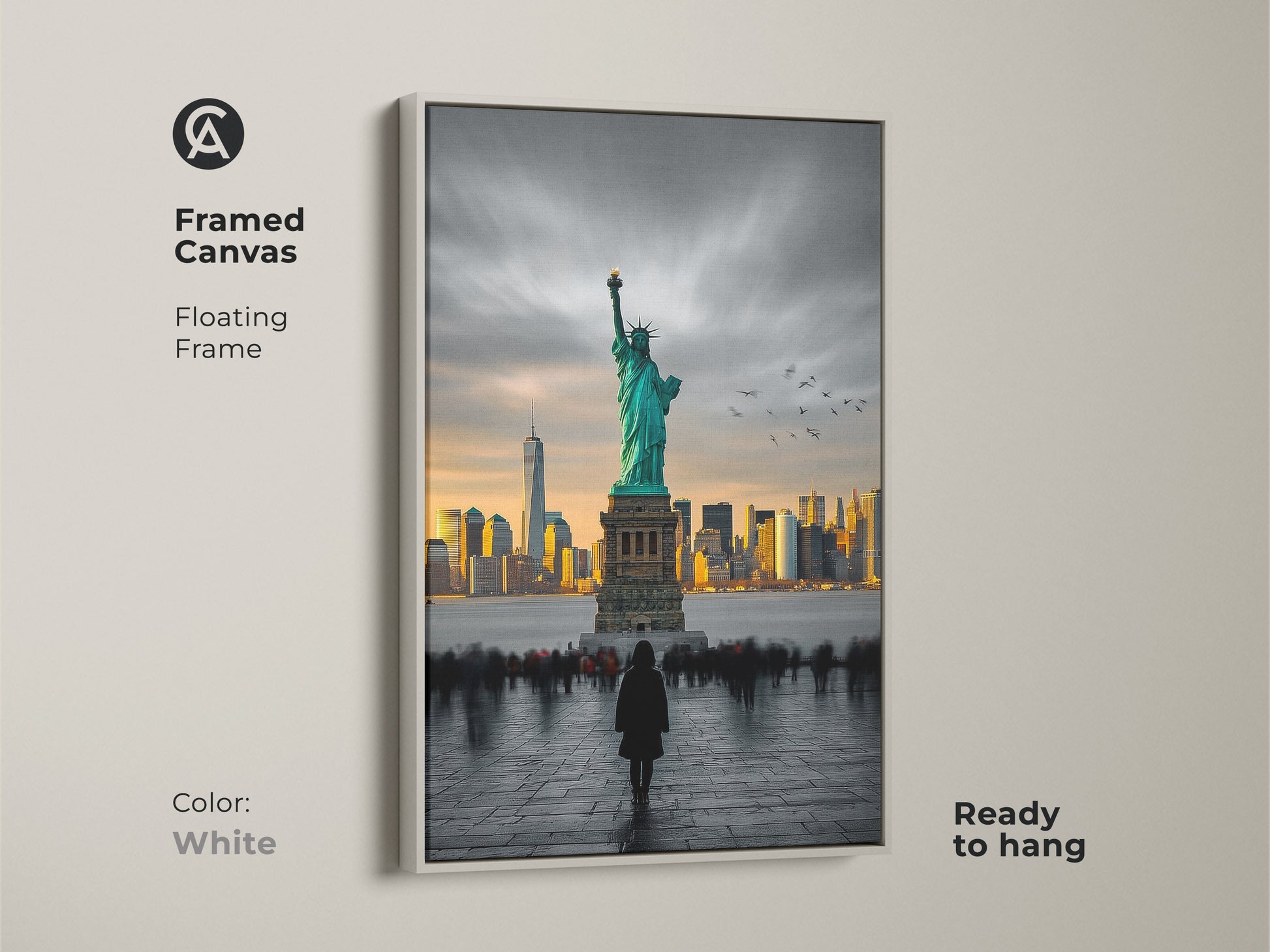 This framed canvas artwork features the Statue of Liberty and the New York City skyline. The frame is a clean white color and comes ready to hang. The image features a person admiring the statue. This floating frame canvas is a great piece for any room.