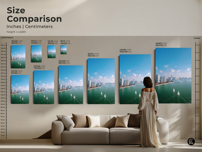 Size comparison of aerial cityscape artwork. See how different canvas and poster sizes look in a living room setting. This visual guide helps you choose the perfect dimensions for your space. The modern travel art featuring sailboats and teal blue tones can transform any room. Find the ideal size for your home decor.