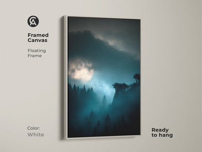 White framed canvas of a deep blue moonlit forest. Misty night landscape wall art for modern homes. This atmospheric forest scene brightens any bedroom decor. The calming blue teal nature artwork adds serenity. A delightful housewarming gift for nature lovers.