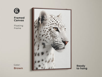 A framed canvas in brown showcases a realistic monochrome snow leopard face. This piece is ready to hang as a sophisticated addition to any space. A great wildlife art for animal lovers.