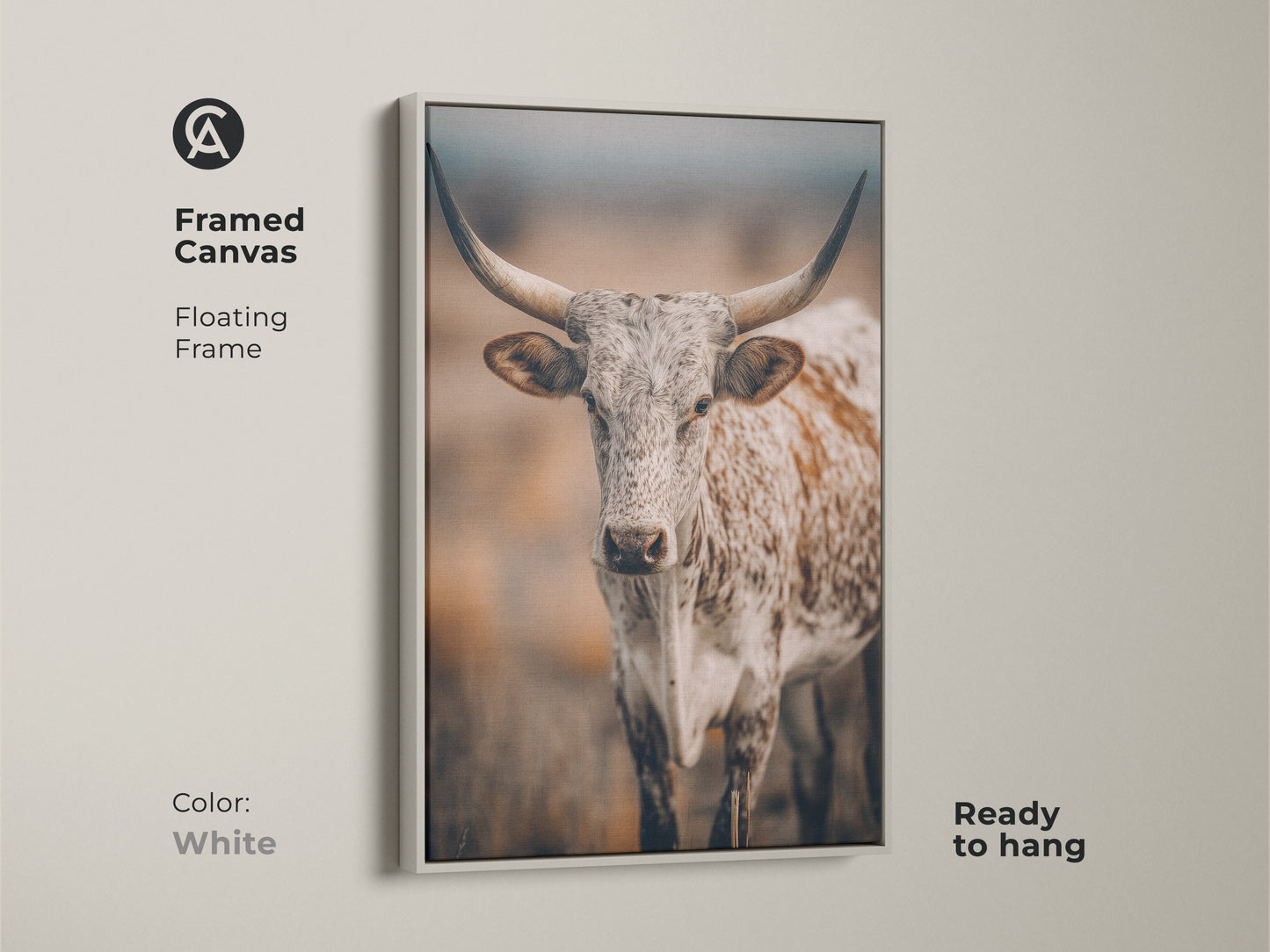 White framed canvas featuring Longhorn Cow artwork. This Texas wildlife canvas print has a floating frame. It is ready to hang. The neutral color palette complements any farmhouse decor. The artwork brings a touch of the country to your home.