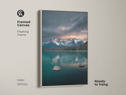 Framed canvas with a floating white frame showcasing a teal lake and snow mountain scene. Ready to hang this scenic artwork enhances your living space. This contemporary nature decor brings a calming touch. Ideal for outdoor enthusiasts. The deep blue gray artwork adds elegance to bedroom walls. Perfect gift.