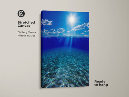Stretched canvas print showcasing underwater sunbeams in a deep blue ocean. This gallery-wrapped artwork has mirror edges and is ready to hang. Ideal coastal beach house decor brings tranquil ocean floor views to your living room or bedroom. It makes a thoughtful housewarming gift.