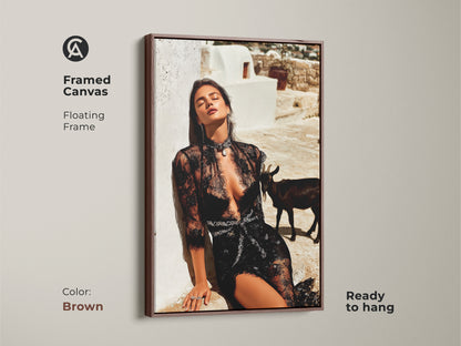 Framed canvas of a glamorous woman in black lace with a brown frame. The editorial fashion artwork includes a goat. This unique goat wall decor enhances eclectic homes. The black white beige art is ready to hang offering sophistication and style.