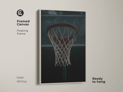 Framed canvas of a basketball hoop with a floating frame in white. This minimalist sports print is ready to hang in any space. This game room artwork adds an athletic touch to your home decor. The urban sports wall art is perfect for a man cave.
