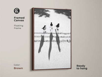 Brown framed canvas of a minimalist birds on music sheet art print. Contemporary floating frame is ready to hang. Ideal for a study or home office wall decor.
