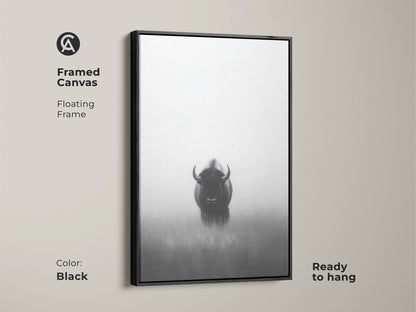 Framed canvas art featuring a black and white bison. This minimalist wildlife artwork with a floating frame is ready to hang. The monochrome animal is printed on a high-quality canvas adding a modern touch to any room. It's perfect as a rustic bison artwork.