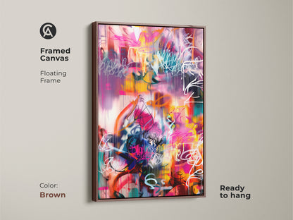 Framed canvas of an abstract painting with a warm brown floating frame. The colorful artwork includes shades of pink yellow teal and white. This ready to hang canvas art brings a contemporary flair to your home or office decor.