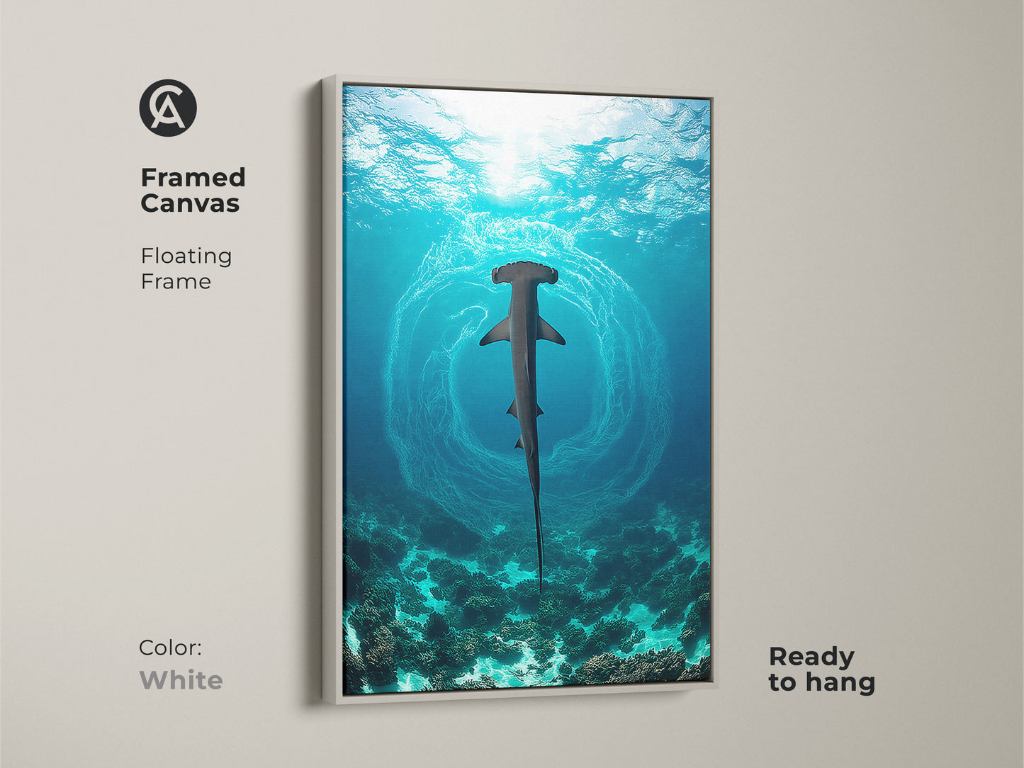Framed art of a hammerhead shark with a floating frame in white. This ocean underwater canvas print is ready to hang. This deep blue teal artwork complements any interior. Perfect for coastal home decor art.