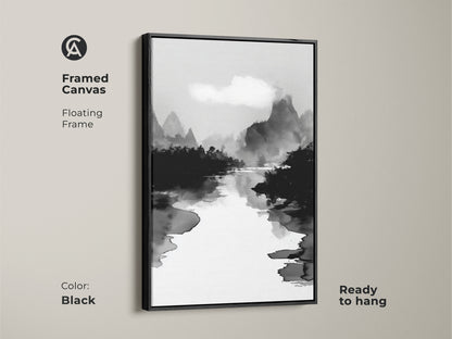 Framed canvas in black displaying a black white ink wash art print. The minimalist mountain river landscape canvas adds calm nature wall decor. The Japanese Sumi-e style artwork is ready to hang. This monochrome home decor enhances any space with serene mountain view art.
