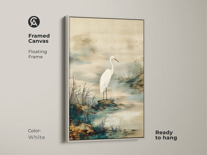 White framed canvas presenting an Egret bird art piece. Japandi style wall art creates a minimalist landscape. Ink wash egret painting in beige and green colors. A serene canvas for your home.