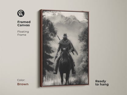 This framed canvas art in brown displays a monochrome cowboy riding a horse. The floating frame enhances this Western landscape artwork. Ready to hang this rustic piece is perfect for a study room or home office. It's a classic adventure themed artwork with black and white tones.