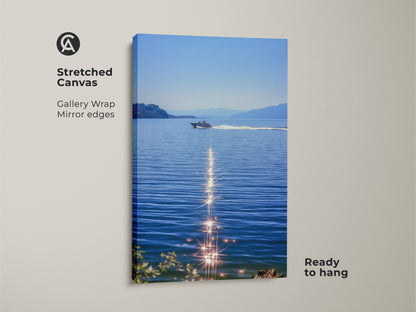 Stretched canvas of a boat on blue water. Sparkling ocean canvas art makes a realistic lake landscape. Ready to hang coastal bedroom wall decor for boat lovers. Enjoy summer water scene art with this nautical home decor print. Modern boat artwork for calm spaces. Perfect as residential wall art.