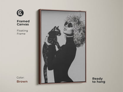 Framed canvas in a brown floating frame featuring a monochrome portrait of a woman with a cat. Black and white glamour fashion art adds a contemporary touch to any home. This ready-to-hang artwork is a unique and stylish gift for cat moms enhancing any room's decor.