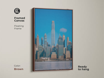 Framed canvas of the New York City skyline in a brown floating frame. Contemporary office decor with modern blue gray wall art. Ready to hang architectural skyline art. Urban city art print perfect for homes that appreciate sophisticated style.