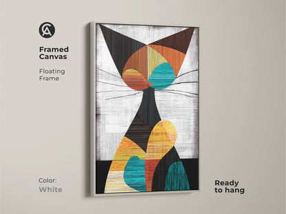 A framed canvas in a white floating frame displays geometric cat art. This animal shape wall art is a modern abstract canvas. It is a unique piece of art for cat people to add to their homes.