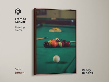 Brown framed canvas features billiard balls on a pool table in emerald green. This floating frame artwork is ready to hang adding a touch of leisure to your space. A perfect piece of sports wall art and a fantastic gift for pool players.