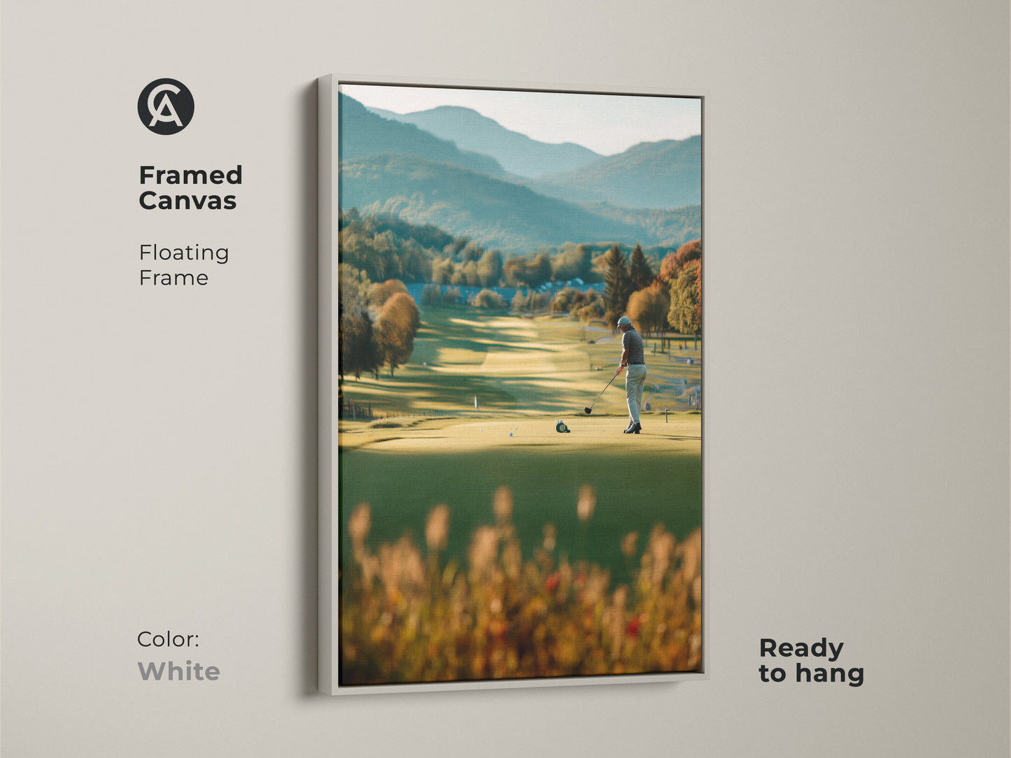 Brighten your walls with this framed canvas golf artwork. This artwork captures a golfer on a green course with mountains in the background. The white floating frame offers a clean and modern look. Ready to hang and enjoy in any room.