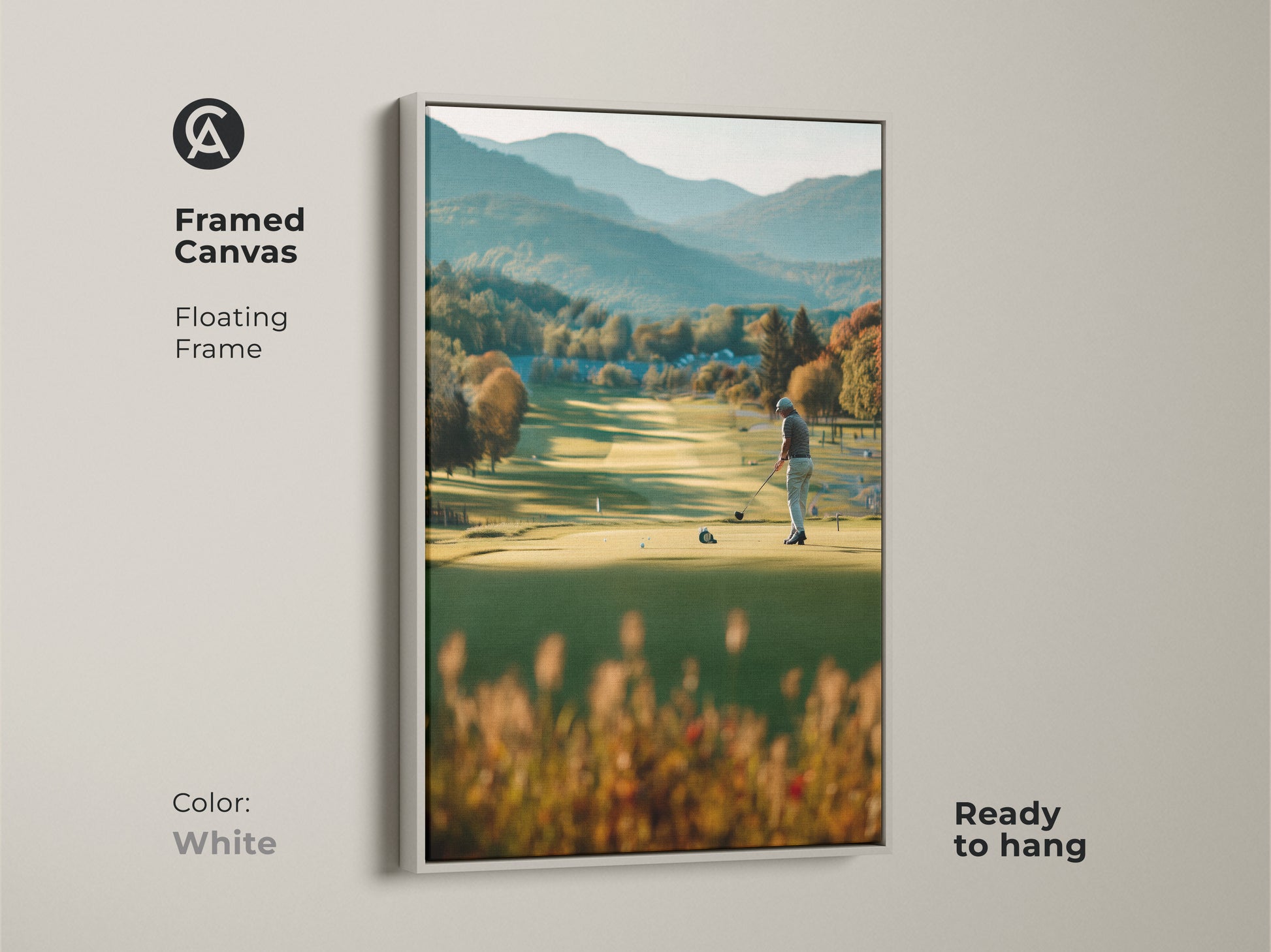 Brighten your walls with this framed canvas golf artwork. This artwork captures a golfer on a green course with mountains in the background. The white floating frame offers a clean and modern look. Ready to hang and enjoy in any room.