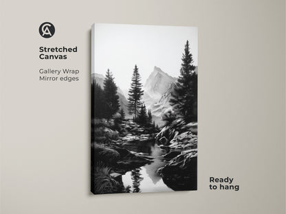 A stretched canvas of a monochrome mountain landscape. The black and white river art includes pine tree wall decor. This rustic home accent is ready to hang. Ideal minimalist nature art for outdoor enthusiasts. Gallery wrapped with mirrored edges.
