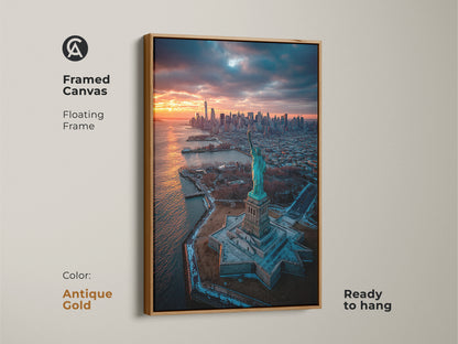 Framed canvas art of the Statue of Liberty at sunset. The antique gold floating frame adds a touch of elegance. Ready to hang this framed canvas enhances any room. This is perfect for adding a classic touch.