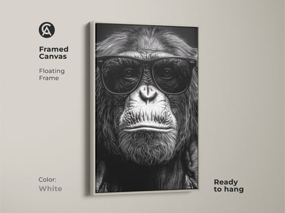 A framed canvas shows a chimpanzee in sunglasses. The white floating frame complements this black and white gorilla art. This primate portrait is ready to hang. Ideal for study room or office decor. Makes a unique animal lover gift. This canvas adds an eclectic touch.