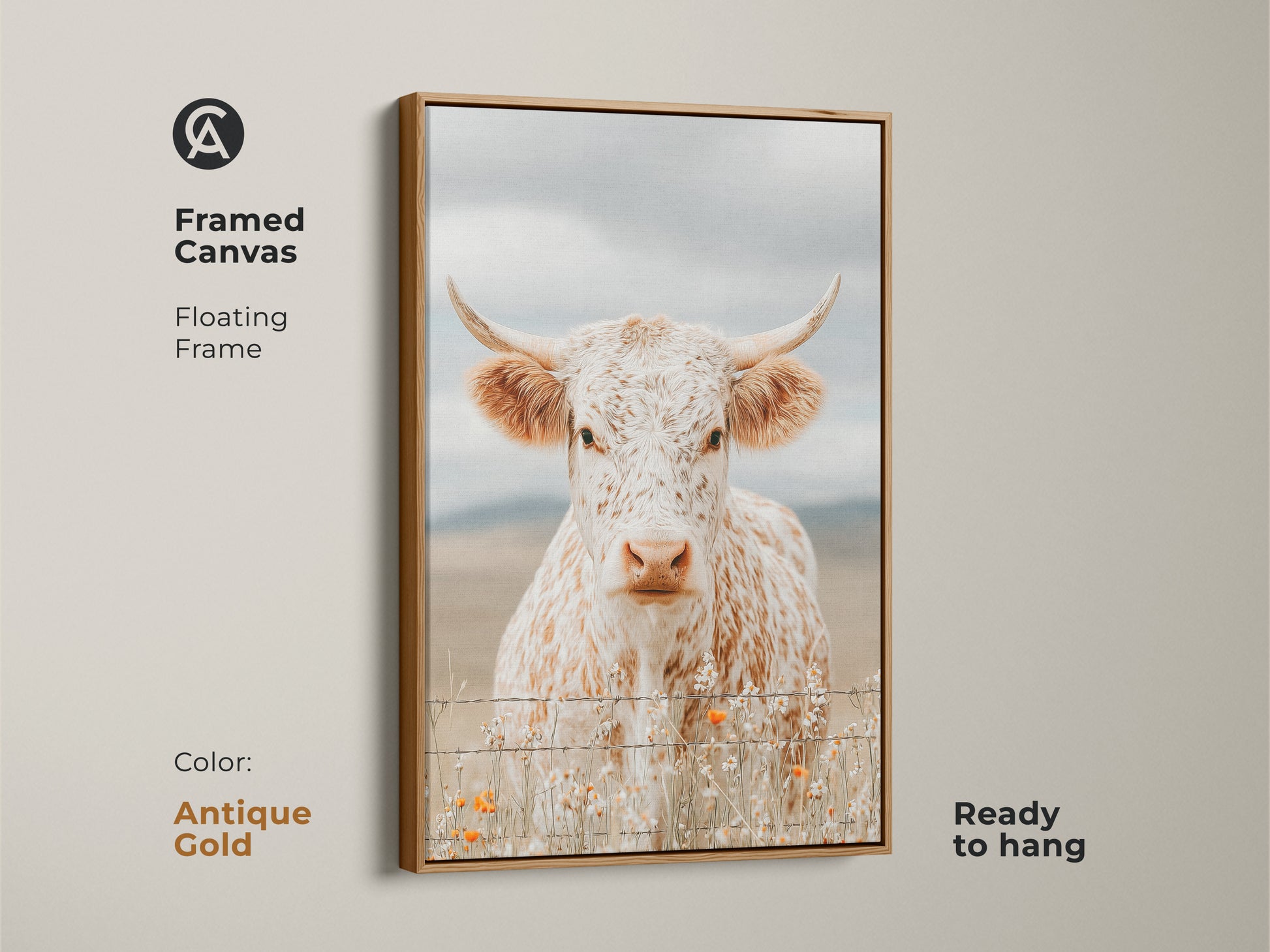 Framed canvas artwork of a white and brown speckled longhorn cow in an antique gold floating frame. The cow is standing behind a barbed wire fence. Orange wildflowers grow at the base. This framed art is ready to hang.