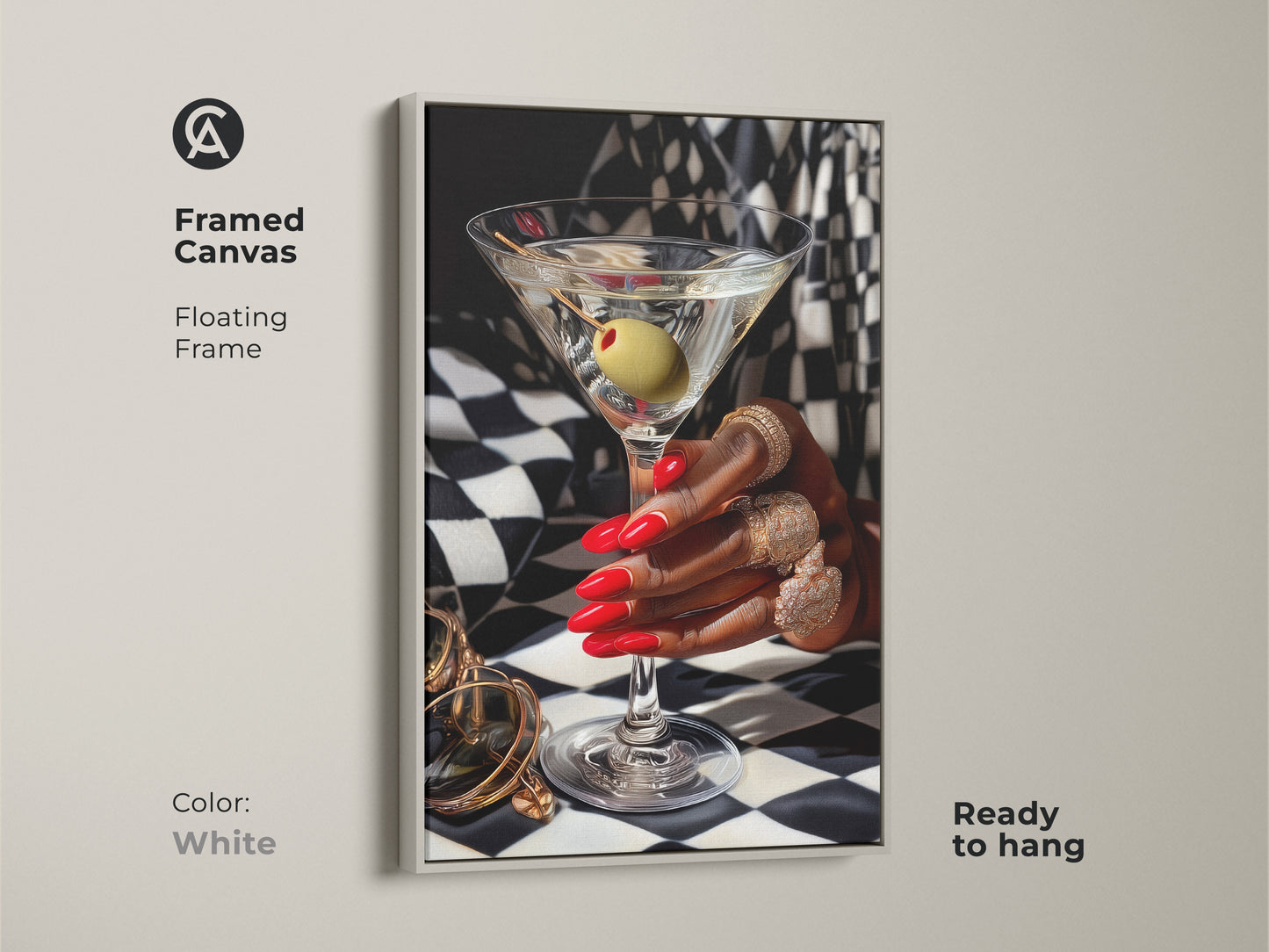 Framed canvas of martini art print with gold jewelry. Art deco artwork featuring red nails and gold rings against a black and white checkered background. White floating frame adds contemporary style. Glamorous bar decor for a luxury home bar. Perfect gift for cocktail lovers ready to hang.