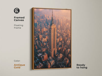 Framed canvas floating frame in antique gold featuring the Empire State Building. A stunning aerial NYC photography print that's ready to hang. The artwork captures a breathtaking golden hour cityscape. Perfect as a sophisticated wall art piece. It adds a contemporary touch to any room. Ideal as a New York themed gift for architecture lovers.