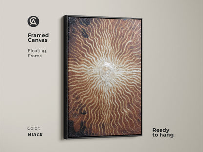 Framed canvas of bronze gold sunburst artwork. This abstract spiral art features a black floating frame. Ready to hang the textured metallic print adds an eclectic touch. Ideal for modern entryway decor and art collectors.