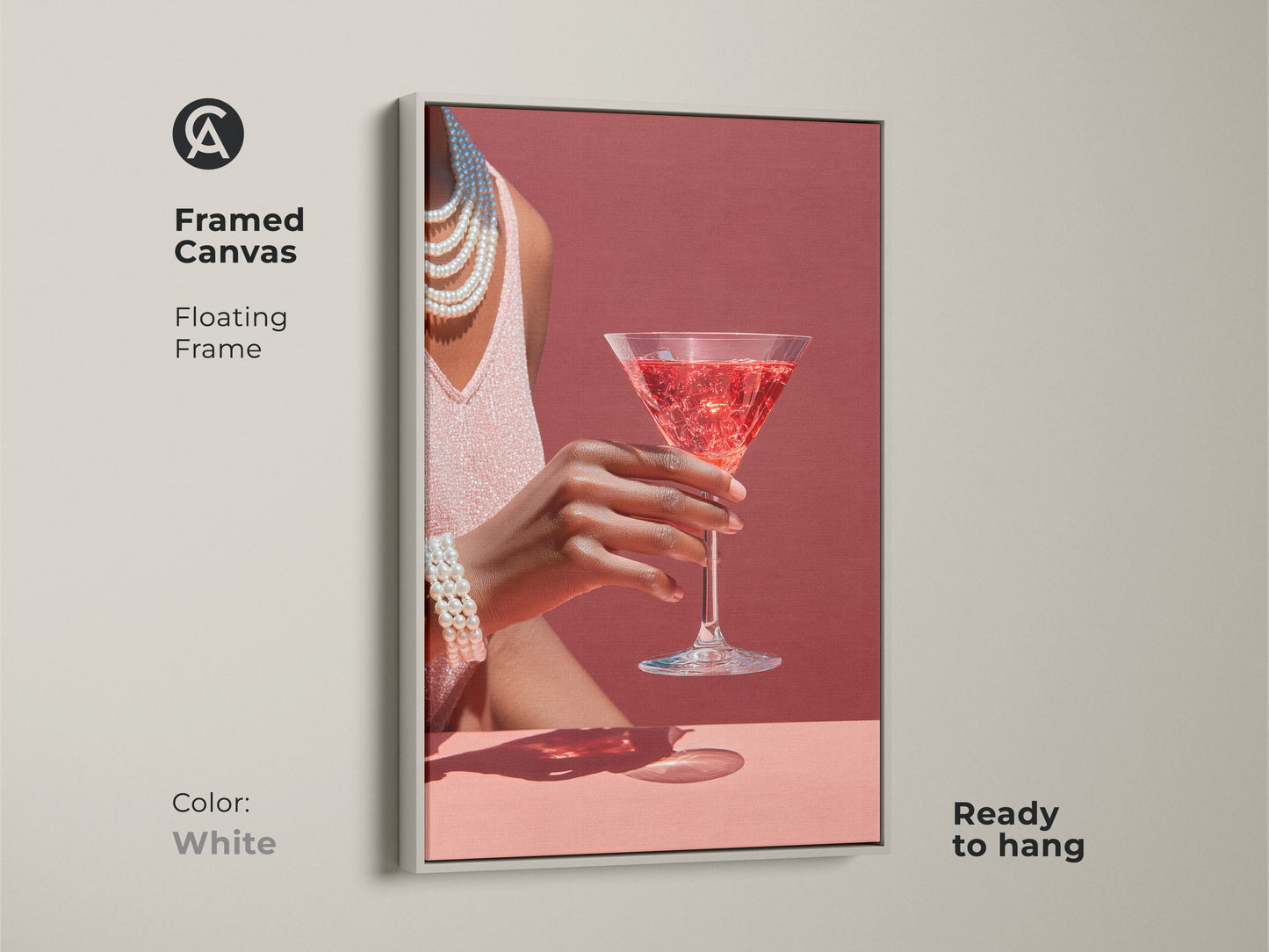 White framed canvas artwork featuring a rose martini cocktail. This glamour bar area wall art has pearl necklace accents. Art deco style cocktail decor is contemporary. It is ready to hang.