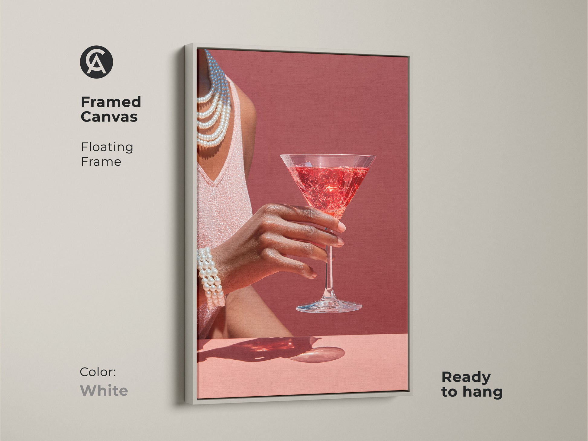 White framed canvas artwork featuring a rose martini cocktail. This glamour bar area wall art has pearl necklace accents. Art deco style cocktail decor is contemporary. It is ready to hang.
