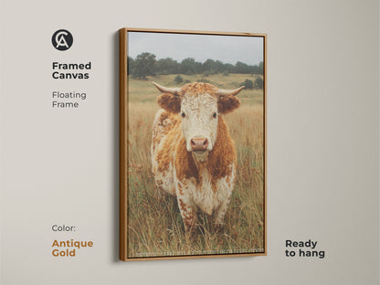 A framed canvas presents a cow portrait with a floating frame in antique gold. The cow stands in a field of dry grass. Ready to hang the canvas offers a vintage touch to animal art. The gold enhances the artwork.