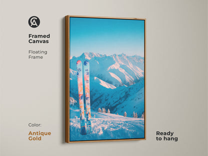 Antique gold framed canvas art print of a winter mountain landscape. A pair of skis are placed in the snow. The floating frame adds a vintage touch to this piece. Ready to hang this artwork brings warmth and elegance to your space. It's ideal for classic decor.