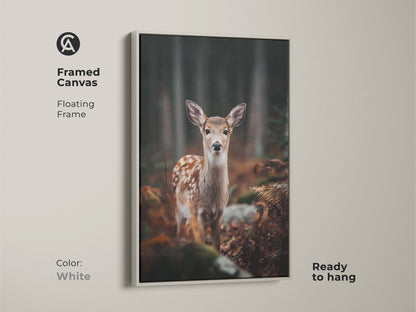 Framed canvas featuring a fawn in forest with white floating frame. Ready to hang this wildlife art adds a touch of nature. Perfect for a cozy bedroom. An ideal gift for animal and nature lovers.