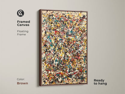 Framed canvas print of abstract splatter art. The artwork has a floating brown frame and is ready to hang. It showcases vibrant splatters of red yellow teal and white. This framed art adds warmth to your space.