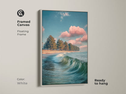 Framed canvas ocean wave art. Floating frame in white. Coastal landscape artwork shows pine trees on a beach. Ready to hang teal blue seascape brings calming nature art to your home.