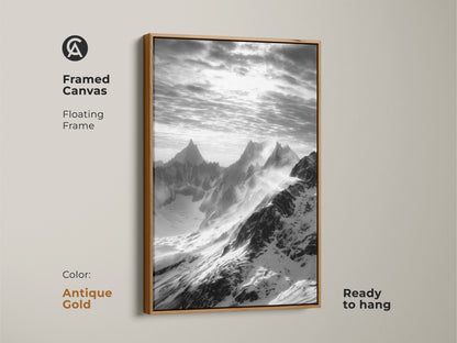Monochrome mountain art in a framed canvas. This snowy peaks canvas print features a floating antique gold frame. This black and white landscape is ready to hang. It's modern nature wall decor for sophisticated spaces.
