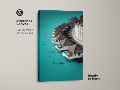 Stretched canvas featuring minimalist overwater bungalows. The turquoise ocean landscape gallery wrap has mirror edges and is ready to hang. This tropical resort wall decor makes a stunning contemporary statement. It is ideal for travel lovers.