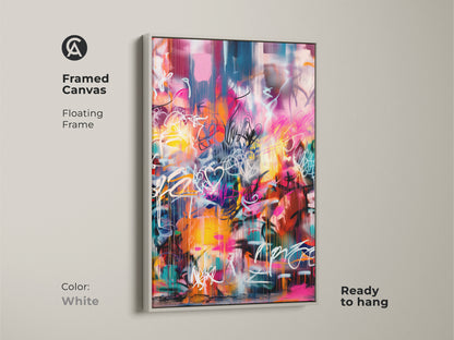 Framed canvas featuring graffiti-style artwork in a white floating frame ready to hang. The modern art piece includes pink yellow and blue colors. The white frame enhances the artwork's vibrant and contemporary style. A fresh addition to any space.