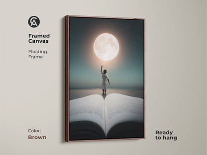 Framed canvas with a floating frame displays a child reaching for the moon. The brown frame complements this ready to hang artwork. The teal moon sky print adds a touch of wonder to any home decor.