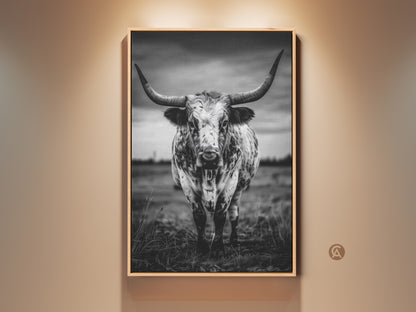 Dramatic black and white longhorn canvas print framed in natural wood. The rustic cow artwork brings a touch of Texas animal decor to any space. Its a striking entryway statement piece. The monochrome palette will complement farmhouse or modern interiors making it a versatile addition to your home or office.