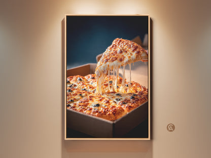 Framed pizza art on a beige wall. The artwork features a slice of pizza being lifted. Melted cheese stretches from the slice. A square pizza in a cardboard box sits below. Buy pizza art to make your walls pop.