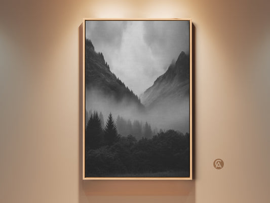 Monochrome Foggy Forest Canvas art print in a oak frame. Black and white mountain landscape wall art for modern nature decor. Misty pine trees add to the atmospheric mountain view. Neutral tone wall art enhances a serene nature artwork.