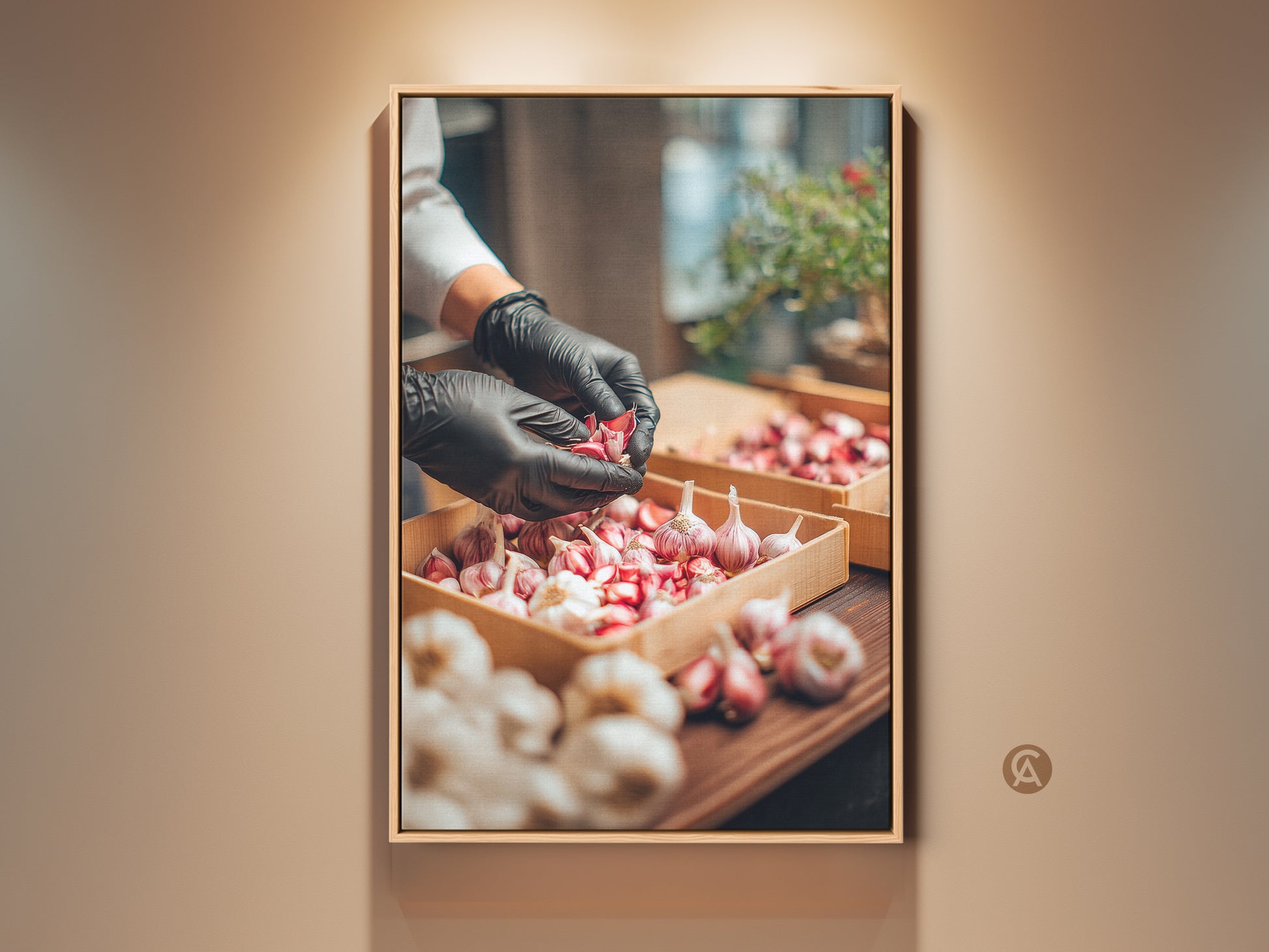 Framed artwork featuring a chef in black gloves preparing garlic. The artwork is a framed canvas. The frame is a light wood color. The wall is a neutral color. Perfect art for kitchen decor.